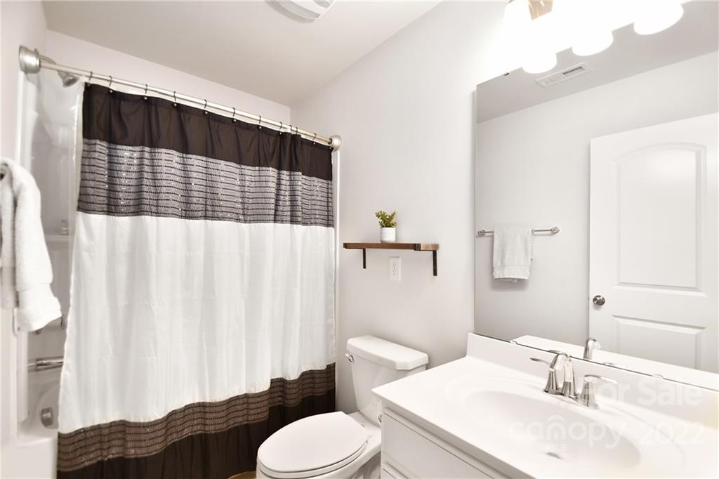 17239 Shearer Road Davidson, NC 28036 - Photo 22 of 32 a bathroom with a sink toilet and shower