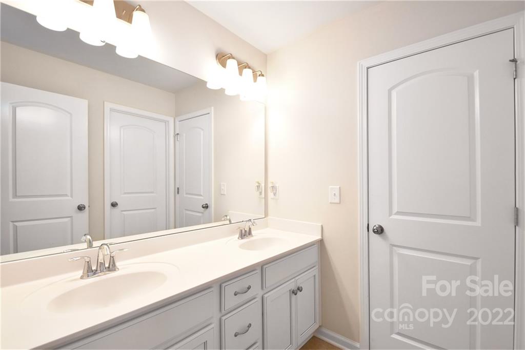 17239 Shearer Road Davidson, NC 28036 - Photo 24 of 32 a bathroom with a double vanity sink mirror and