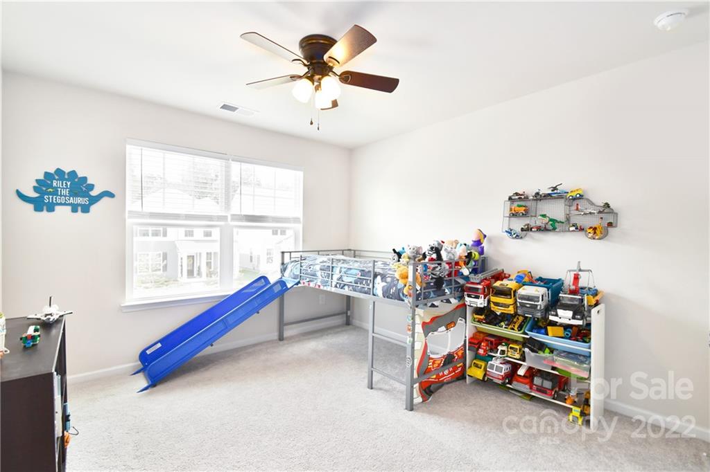 17239 Shearer Road Davidson, NC 28036 - Photo 26 of 32 a bedroom with furniture and a chandelier