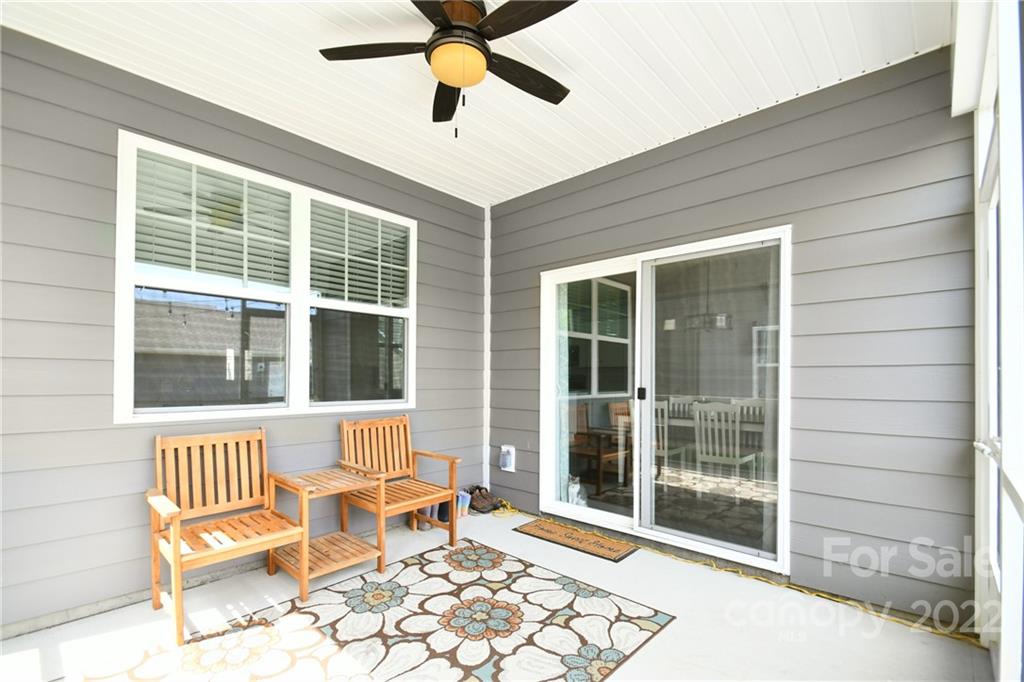 17239 Shearer Road Davidson, NC 28036 - Photo 28 of 32 a view of a patio with a table and chairs and floor to ceiling window