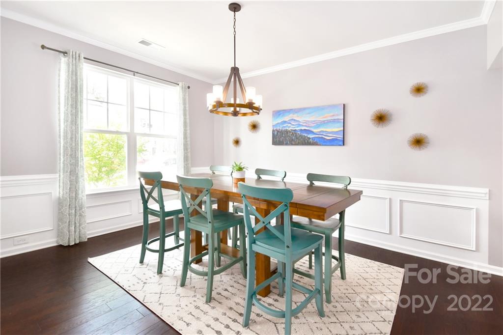 17239 Shearer Road Davidson, NC 28036 - Photo 4 of 32 a dining room with wooden floor and a chandelier