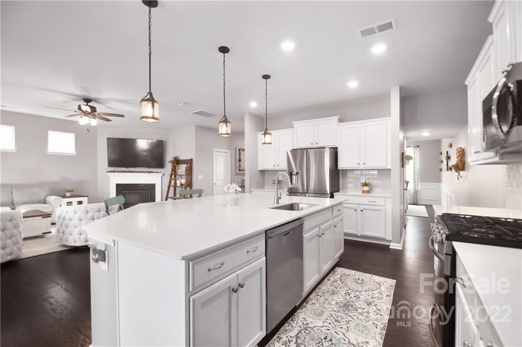 17239 Shearer Road Davidson, NC 28036 - Photo 9 of 32 a kitchen with a sink a counter top space stainless steel appliances and cabinets