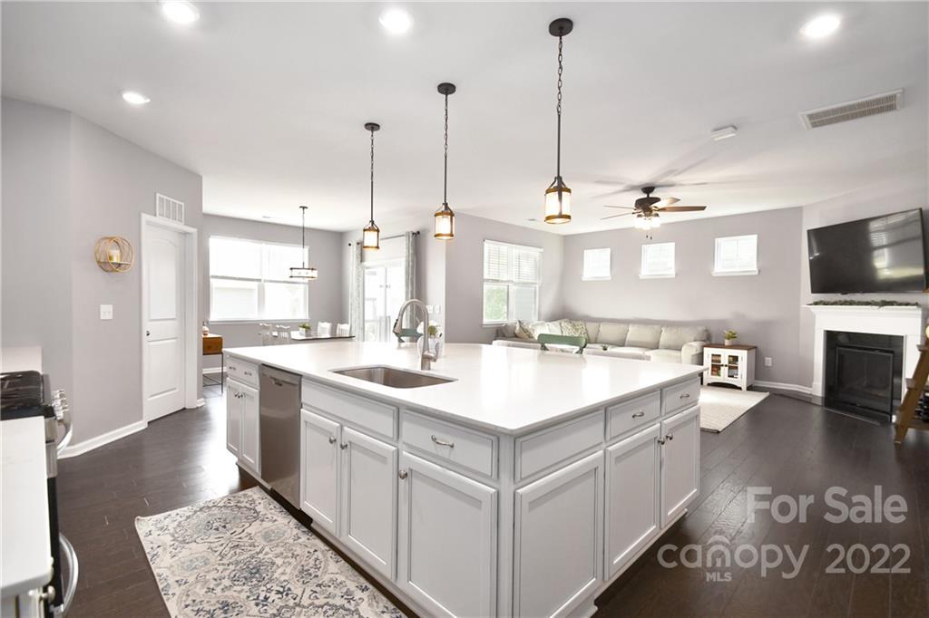 17239 Shearer Road Davidson, NC 28036 - Photo 10 of 32 a large kitchen with kitchen island a sink stove and wooden floor