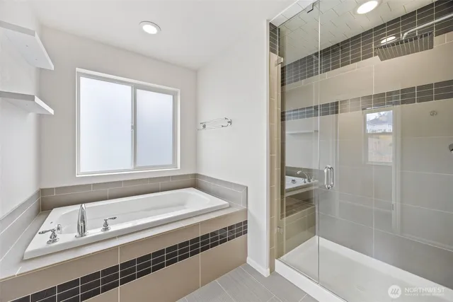 a bathroom with a tub and a shower