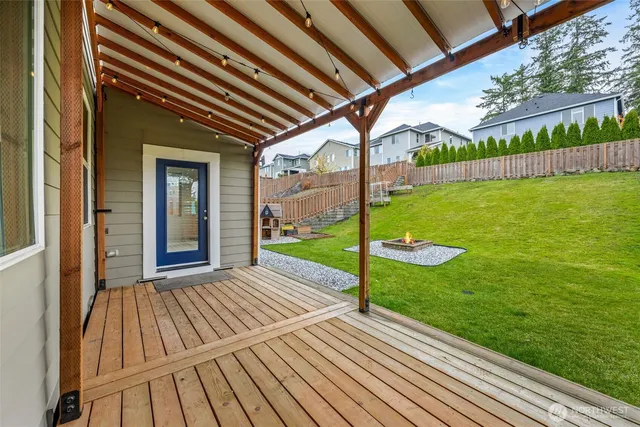a view of a backyard with a garden and deck