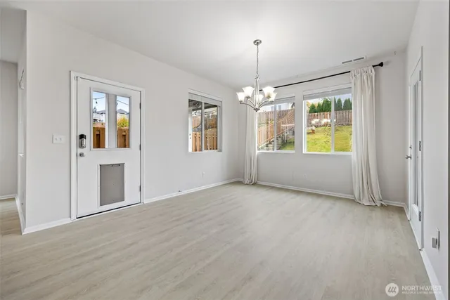 an empty room with windows and entrance