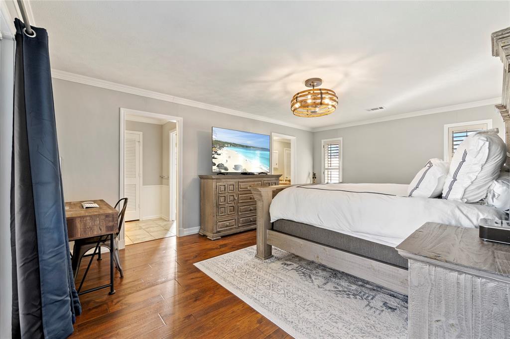 7116 Hunters Ridge Drive Dallas, TX 75248 - Photo 13 of 33 a bedroom with a bed and wooden floor