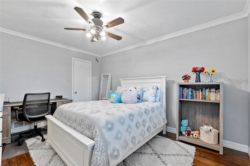 7116 Hunters Ridge Drive Dallas, TX 75248 - Photo 19 of 33 a bedroom with a bed and book shelf
