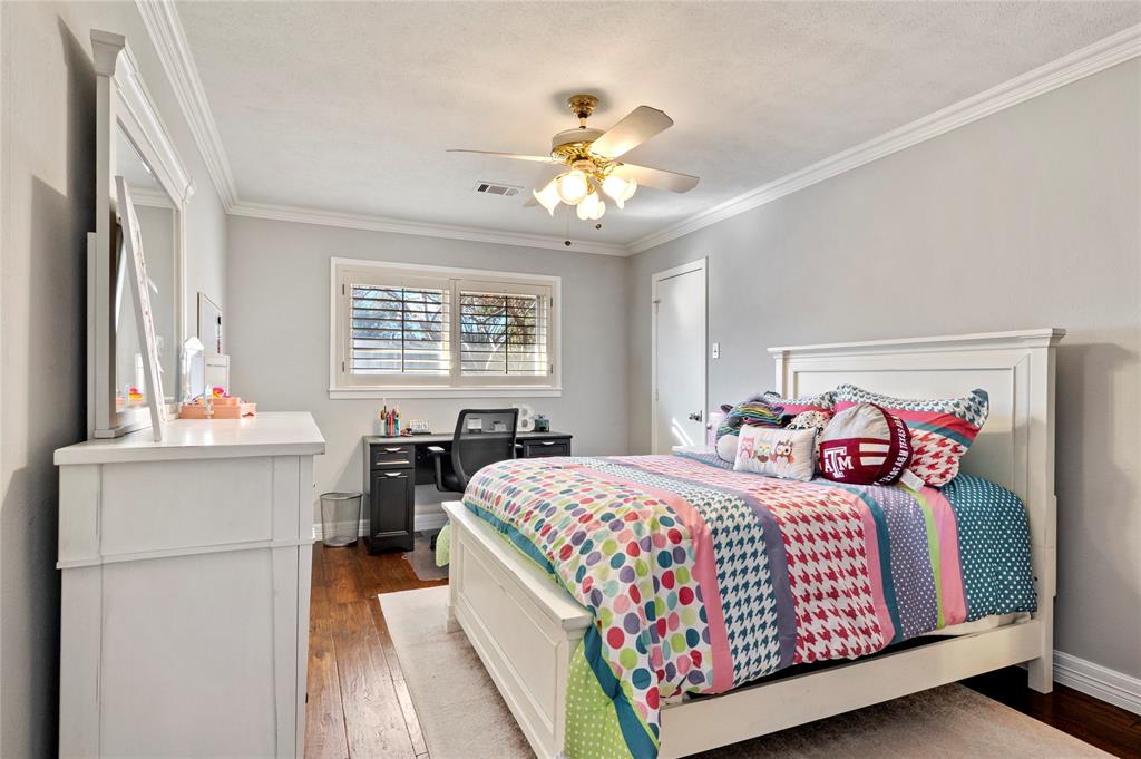 7116 Hunters Ridge Drive Dallas, TX 75248 - Photo 20 of 33 a bedroom with a bed and a chandelier