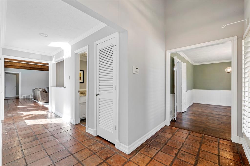 7116 Hunters Ridge Drive Dallas, TX 75248 - Photo 2 of 33 a view of a hallway view with wooden floor and dining room