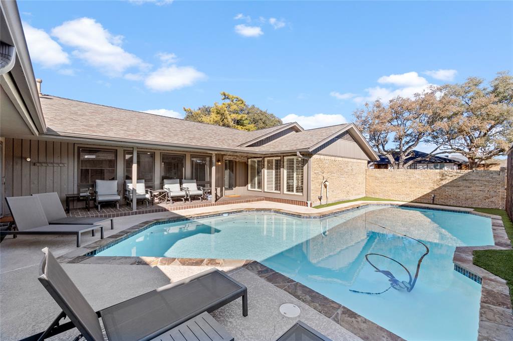 7116 Hunters Ridge Drive Dallas, TX 75248 - Photo 26 of 33 a view of a house with swimming pool and sitting area