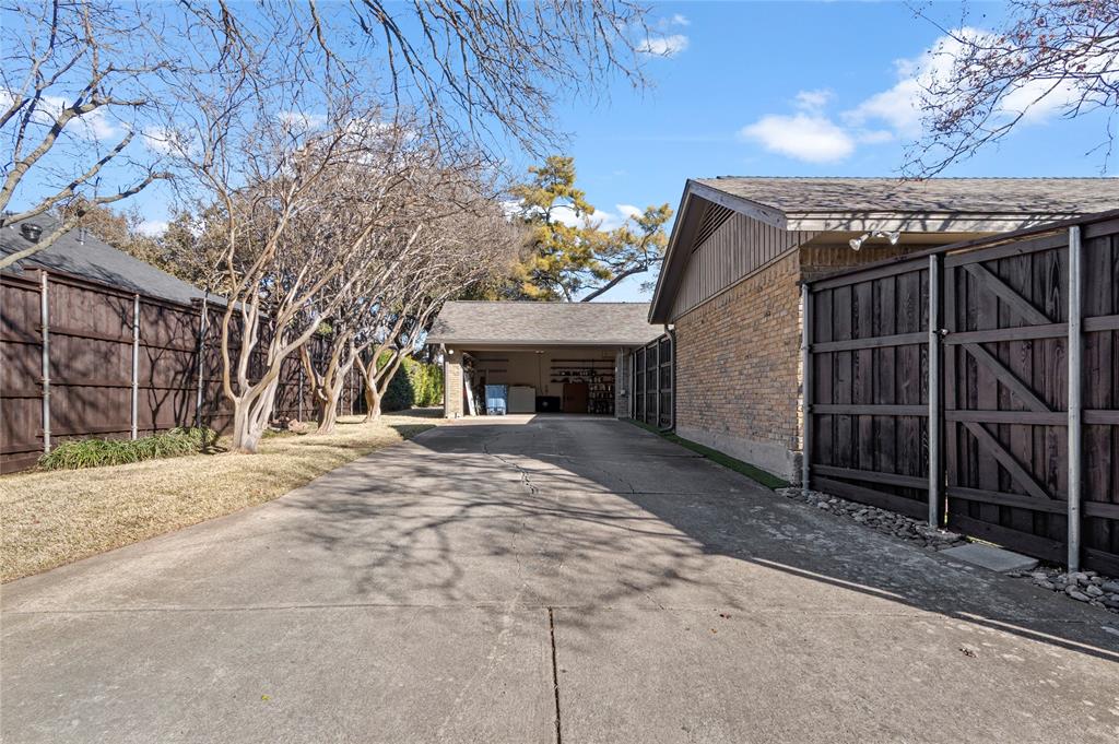 7116 Hunters Ridge Drive Dallas, TX 75248 - Photo 29 of 33 a view of a house with a yard and garage