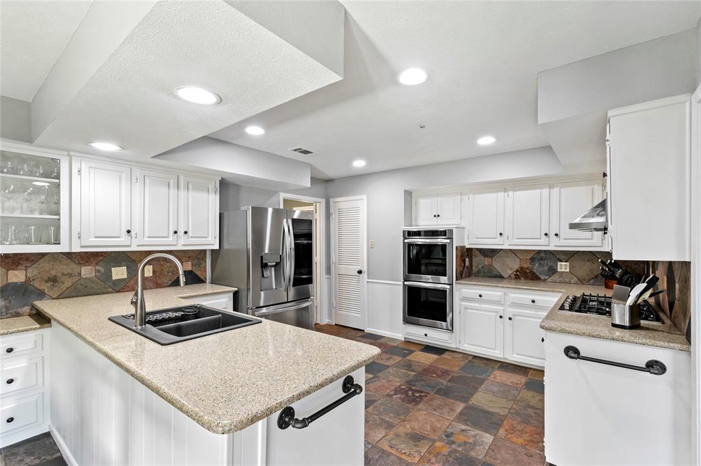 7116 Hunters Ridge Drive Dallas, TX 75248 - Photo 8 of 33 a kitchen with a stove a sink and a refrigerator