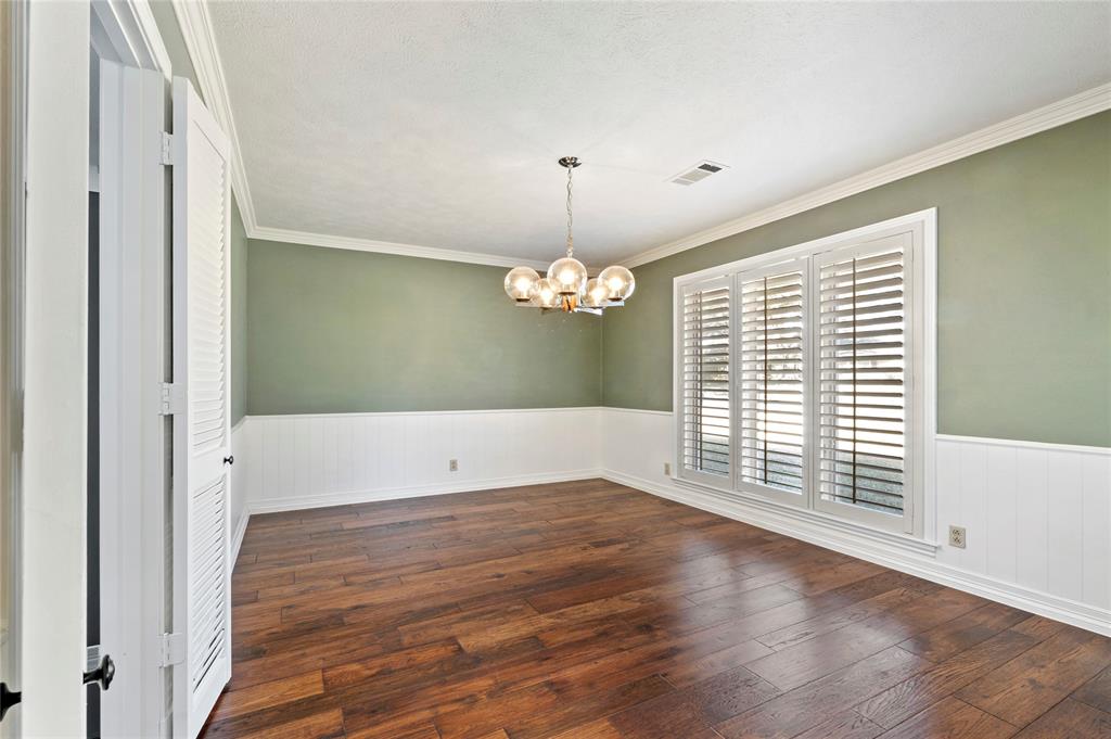 7116 Hunters Ridge Drive Dallas, TX 75248 - Photo 10 of 33 a view of a room with wooden floor chandelier and a window