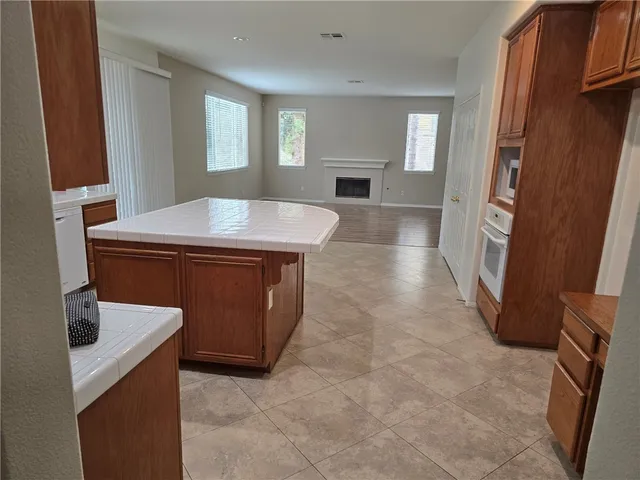 a view of empty room with window and fireplace
