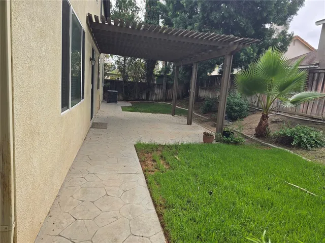 a view of a backyard with table and chairs and a small yard