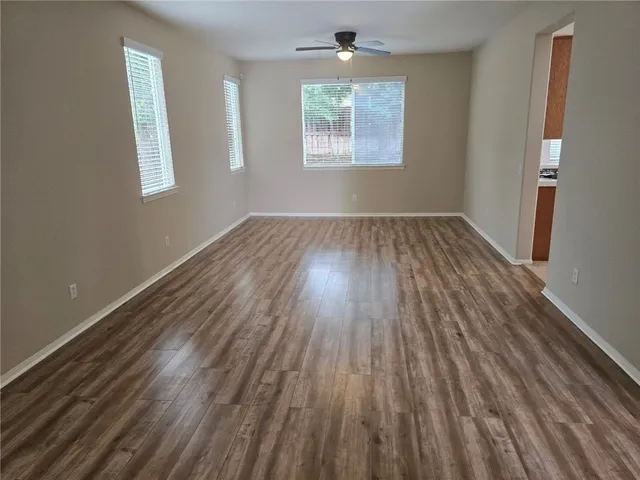 a view of kitchen with a sink a microwave and cabinets