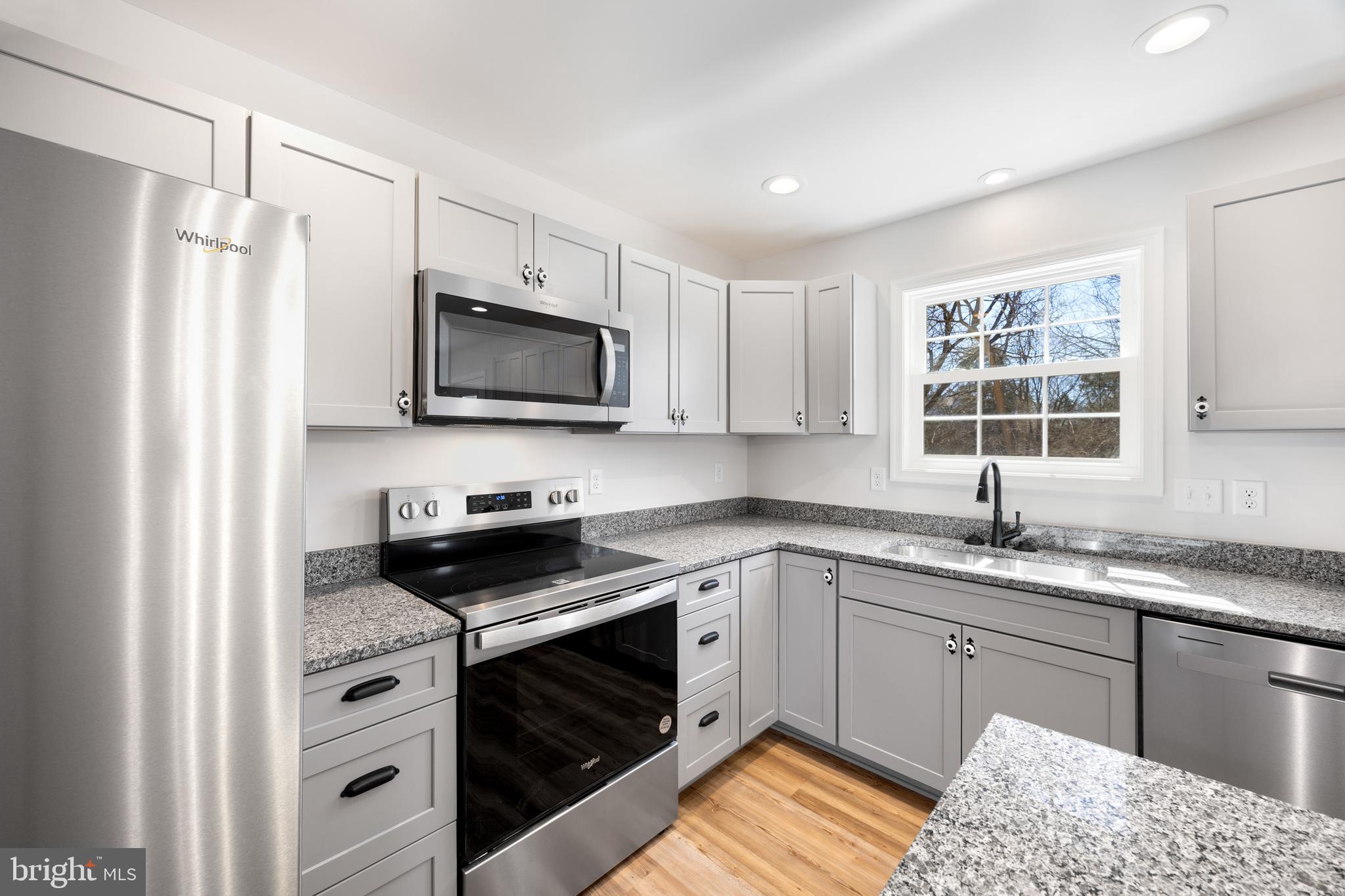 13518 Senedo Road Mount Jackson, VA 22842 - Photo 11 of 22 a kitchen with stainless steel appliances granite countertop a stove a sink and a microwave