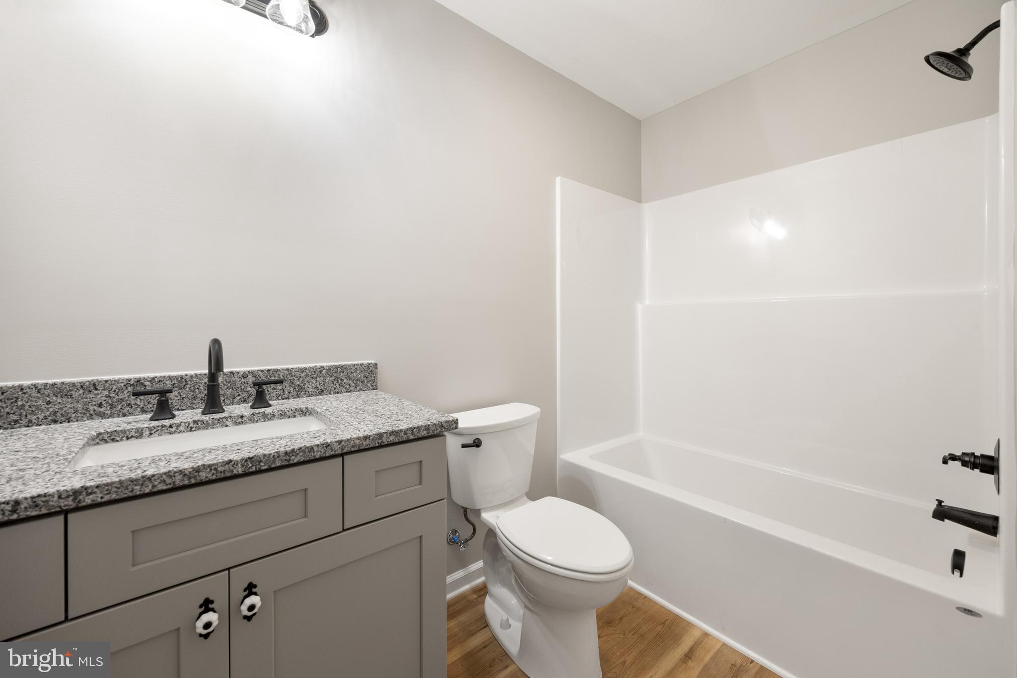 13518 Senedo Road Mount Jackson, VA 22842 - Photo 16 of 22 a bathroom with a granite countertop sink a toilet and shower