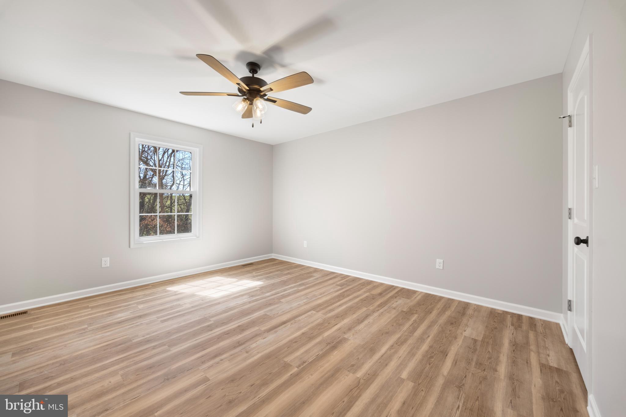 13518 Senedo Road Mount Jackson, VA 22842 - Photo 17 of 22 a view of an empty room with wooden floor and a window