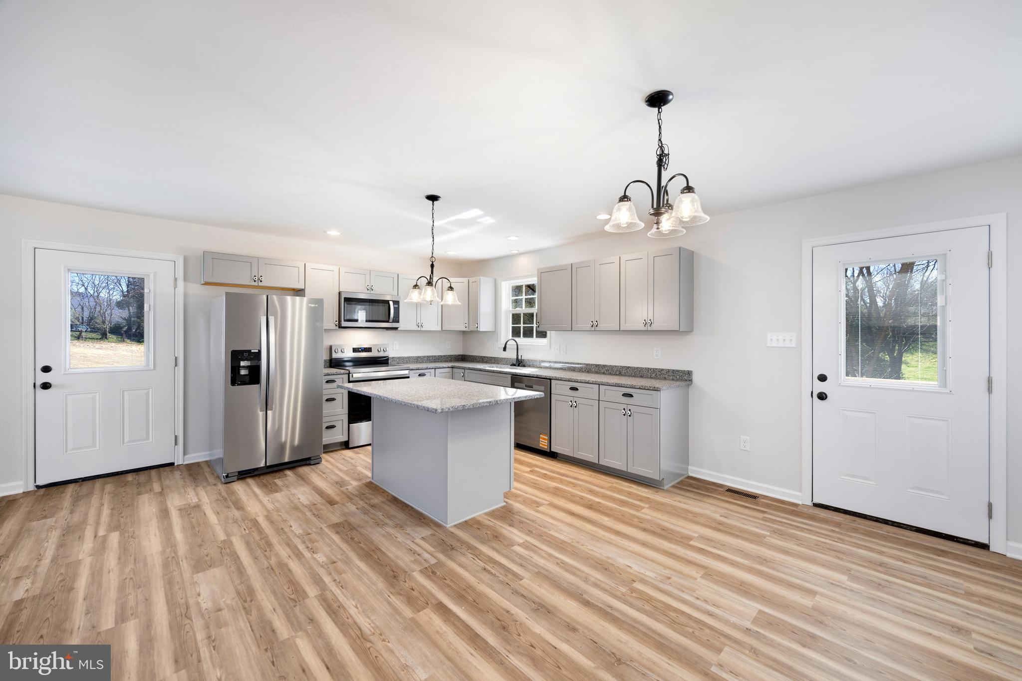 13518 Senedo Road Mount Jackson, VA 22842 - Photo 8 of 22 a kitchen with stainless steel appliances kitchen island wooden floors and white cabinets