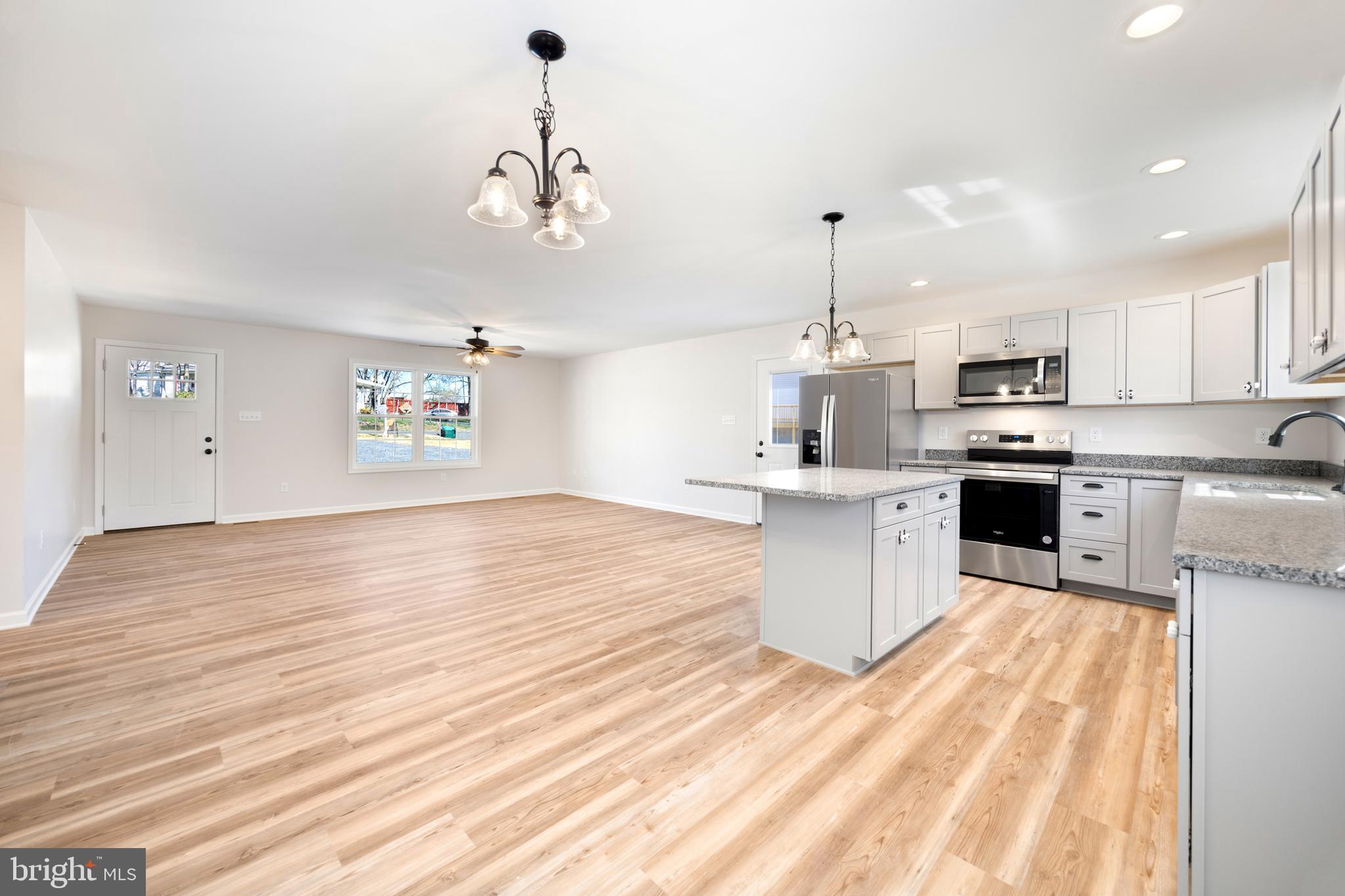 13518 Senedo Road Mount Jackson, VA 22842 - Photo 9 of 22 a kitchen with granite countertop a stove a sink dishwasher and a oven with wooden floor
