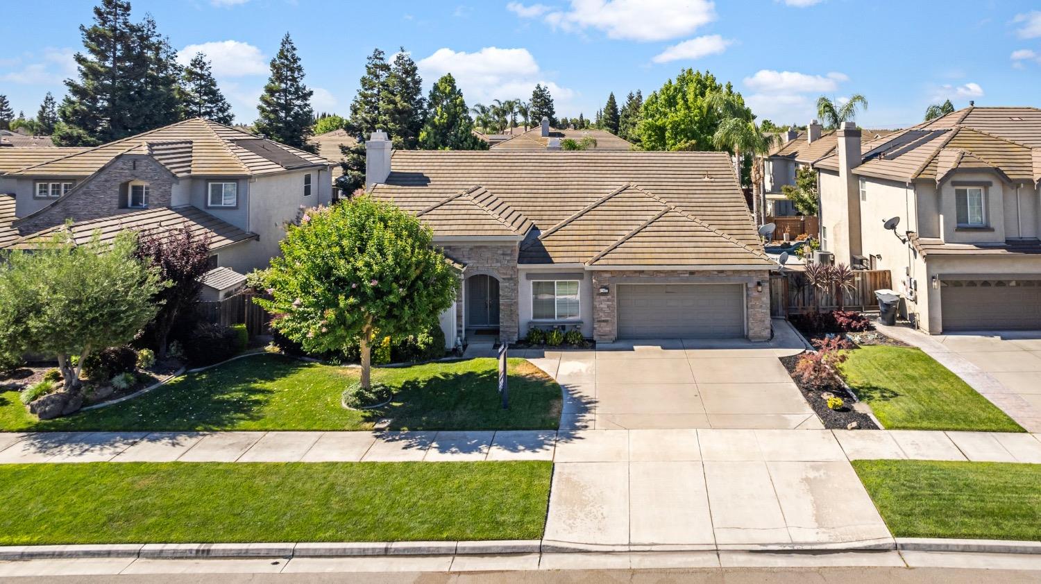 382 John Kamps Way Ripon, CA 95366 - Photo 1 of 1 a front view of a house with a yard and garage