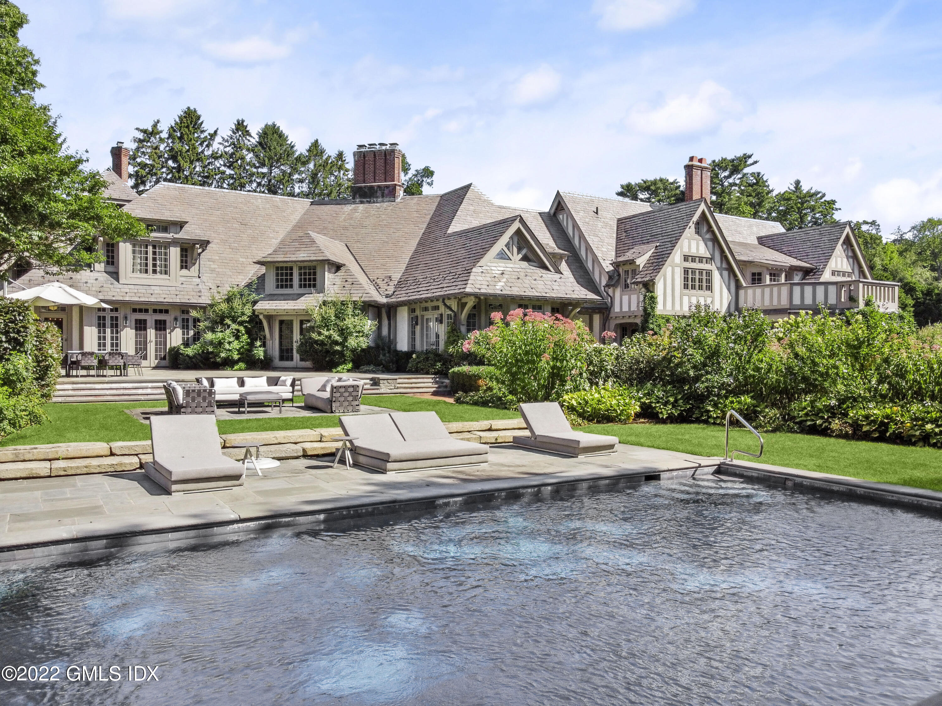164 Round Hill Road Greenwich, CT 06831 - Photo 2 of 67 an aerial view of a house with swimming pool patio and outdoor seating