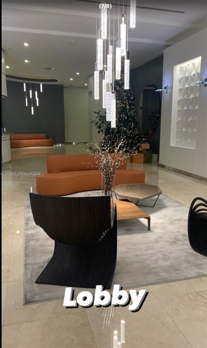 9066 Southwest 73rd Court, Unit 1903 Miami, FL 33156 - Photo 3 of 7 a room with table and chairs