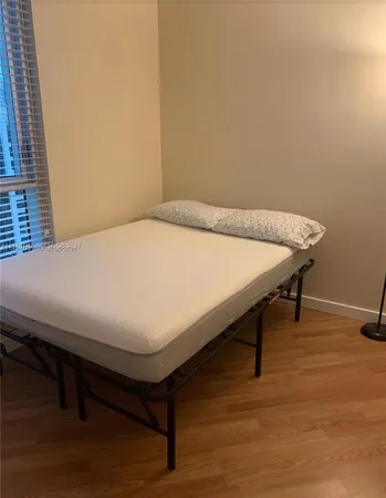 a bed sitting in a room next to a window