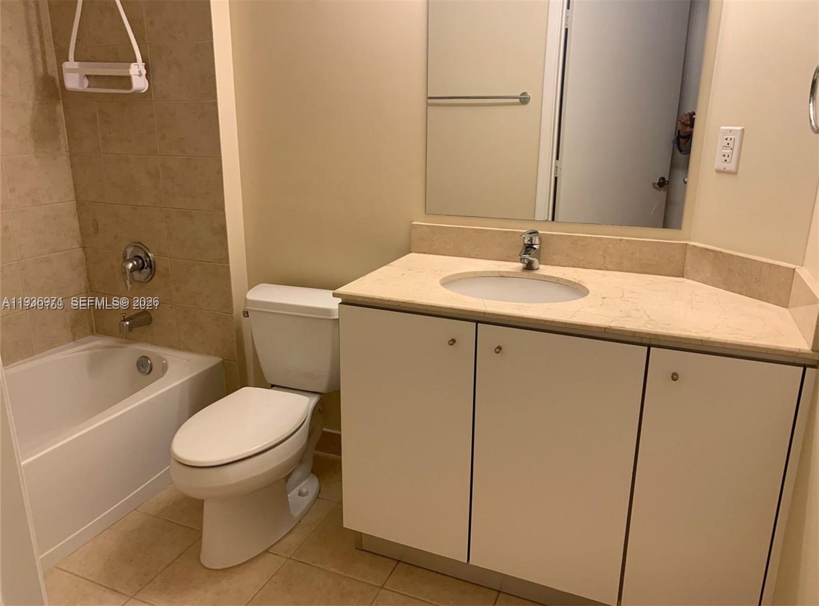9066 Southwest 73rd Court, Unit 1903 Miami, FL 33156 - Photo 6 of 7 a bathroom with a sink toilet and shower