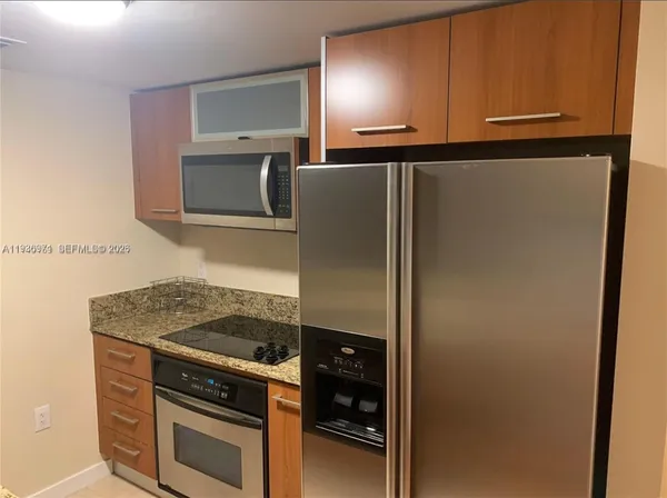 a kitchen with a refrigerator and cabinets