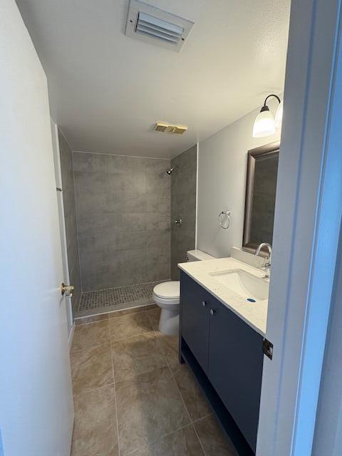 21938 Remsen Terrace, Unit 209 Boca Raton, FL 33433 - Photo 17 of 22 a bathroom with a sink a toilet and shower