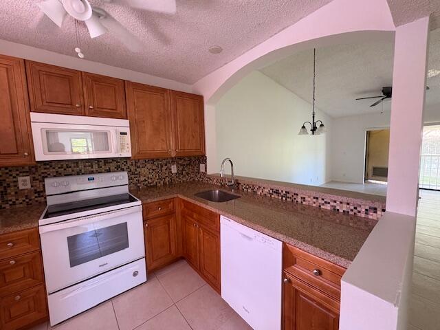 21938 Remsen Terrace, Unit 209 Boca Raton, FL 33433 - Photo 5 of 22 a kitchen with granite countertop a stove sink and cabinets
