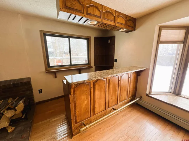 a living room with furniture gym equipment and a large window