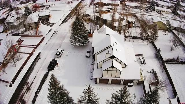 a view of a hallway with wooden floor and cabinet