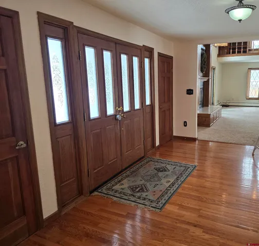 a view of empty room with a fireplace and a chandelier