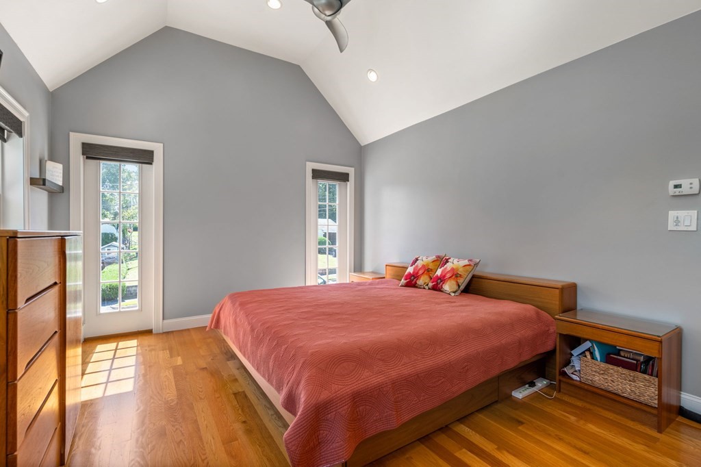 105 Brewster Road Waltham, MA 02451 - Photo 12 of 32 a bedroom with a bed and wooden floor