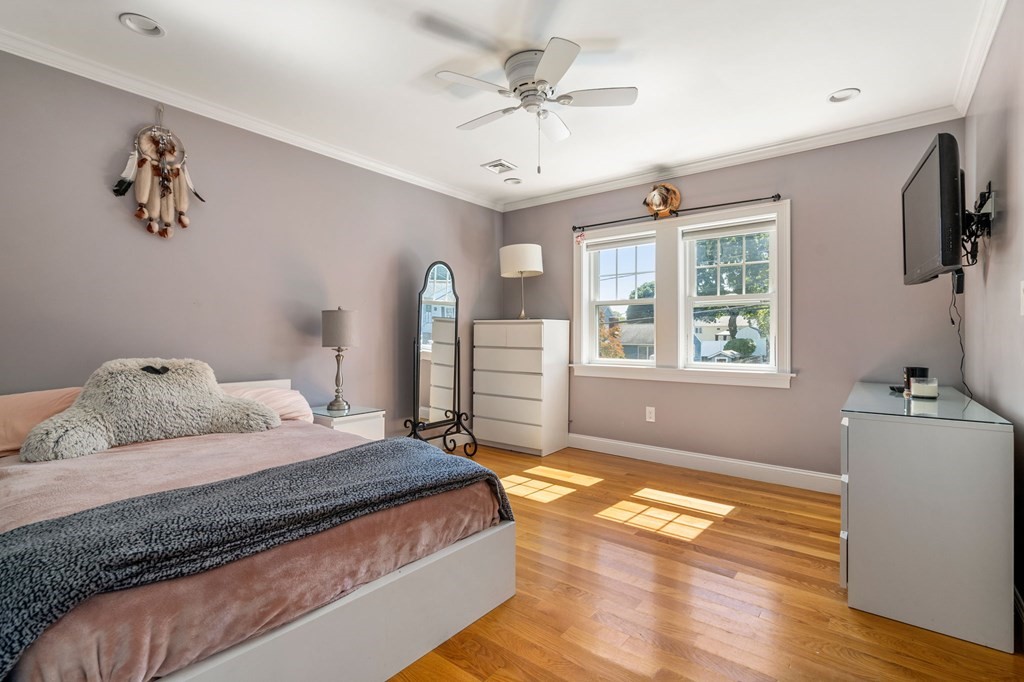 105 Brewster Road Waltham, MA 02451 - Photo 17 of 32 a spacious bedroom with a bed and a window
