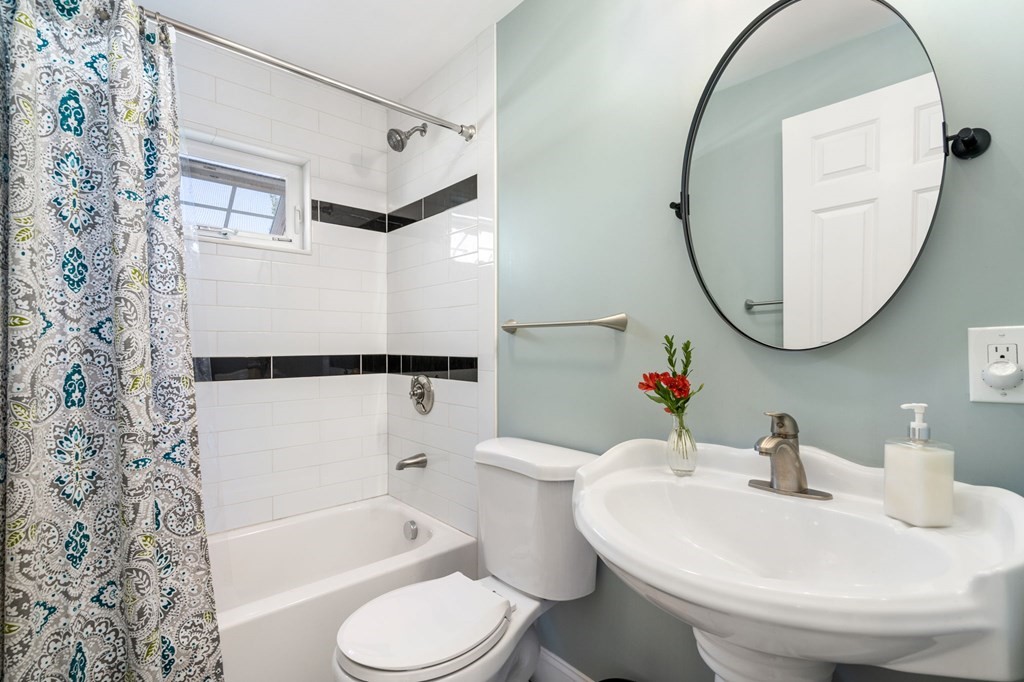 105 Brewster Road Waltham, MA 02451 - Photo 19 of 32 a white toilet sitting next to a bathroom sink and tub