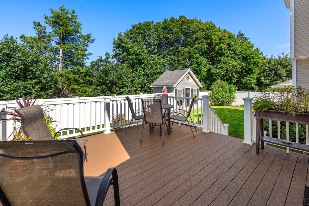 105 Brewster Road Waltham, MA 02451 - Photo 21 of 32 a view of a deck with wooden floor and outdoor seating