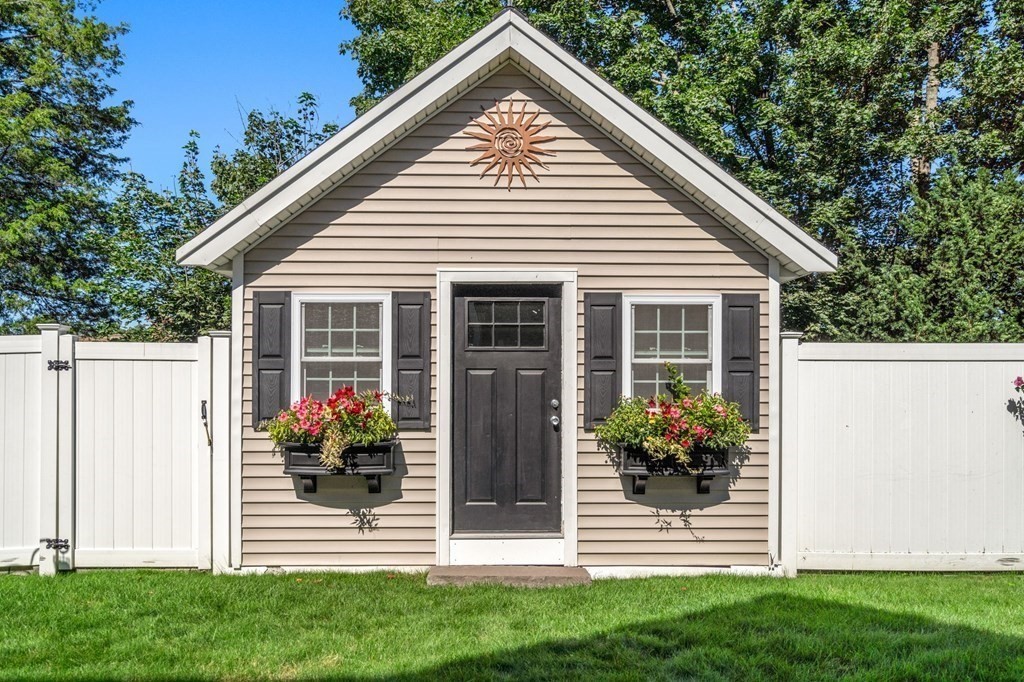 105 Brewster Road Waltham, MA 02451 - Photo 25 of 32 a front view of a house with a garden