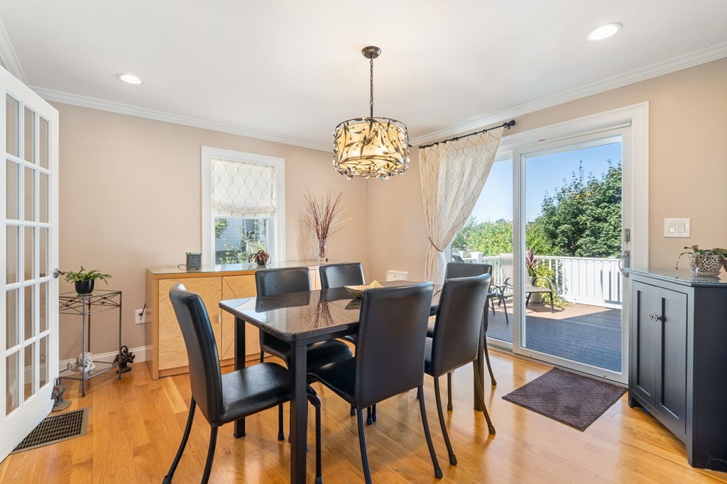 105 Brewster Road Waltham, MA 02451 - Photo 8 of 32 a dining room with furniture a chandelier and wooden floor