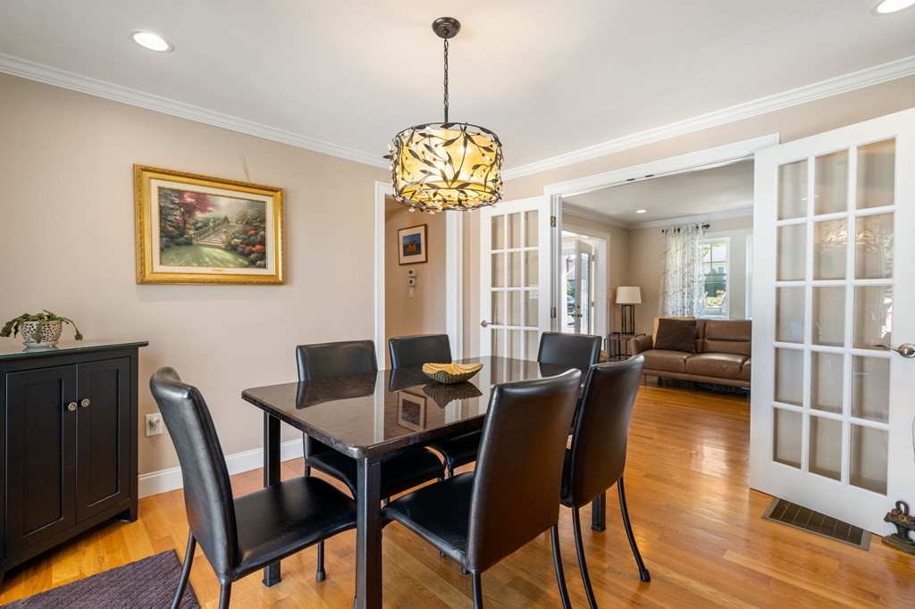105 Brewster Road Waltham, MA 02451 - Photo 9 of 32 a view of a dining room with furniture wooden floor and a chandelier