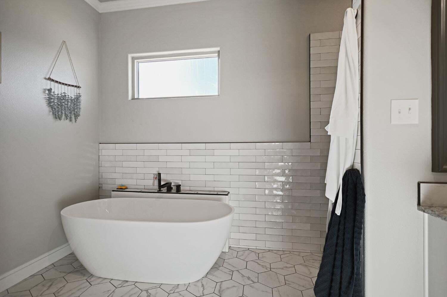 3416 141st Street Lubbock, TX 79423 - Photo 14 of 32 a bathroom with a sink a mirror and a shower