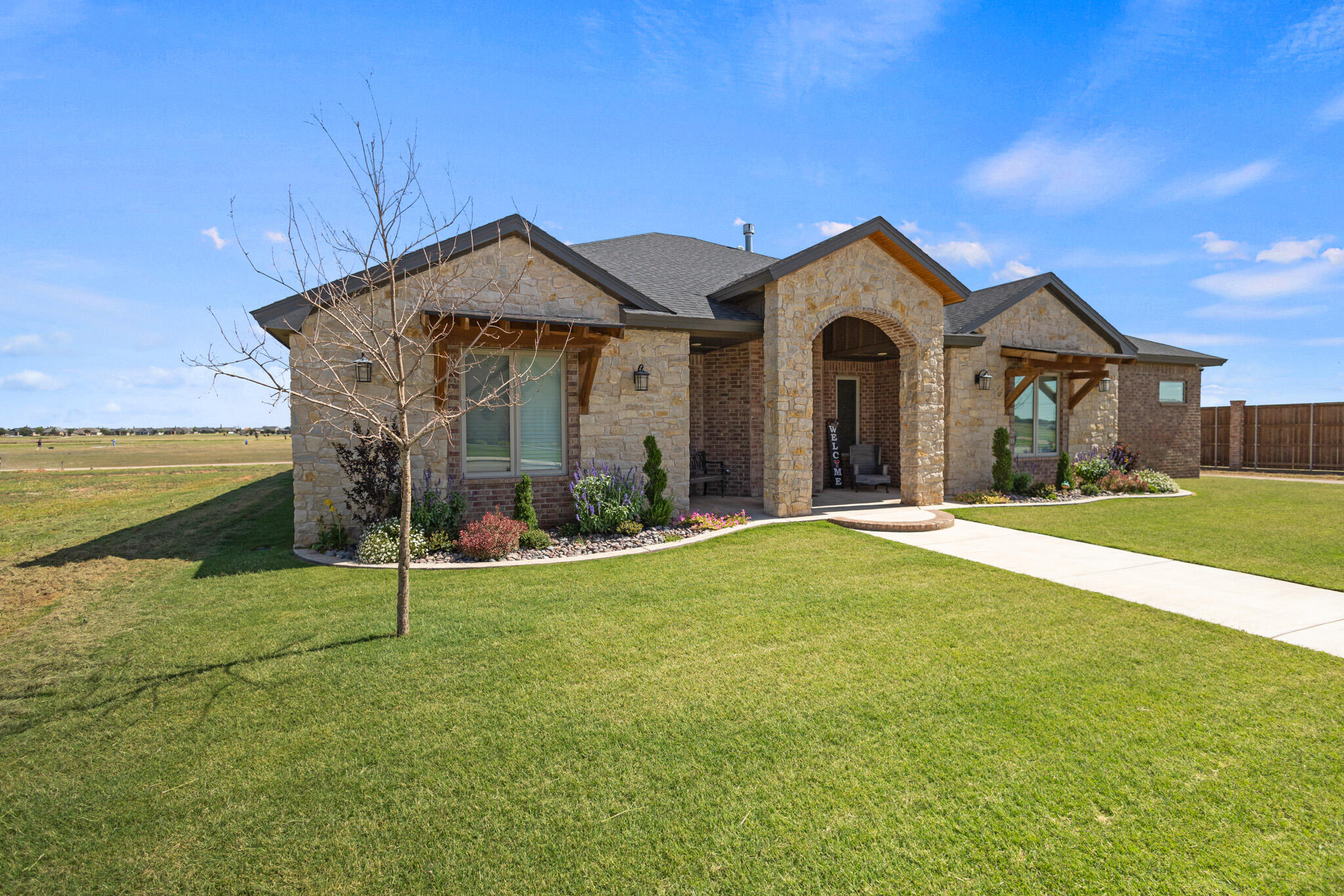 3416 141st Street Lubbock, TX 79423 - Photo 2 of 32 a view of a house with a yard and large tree