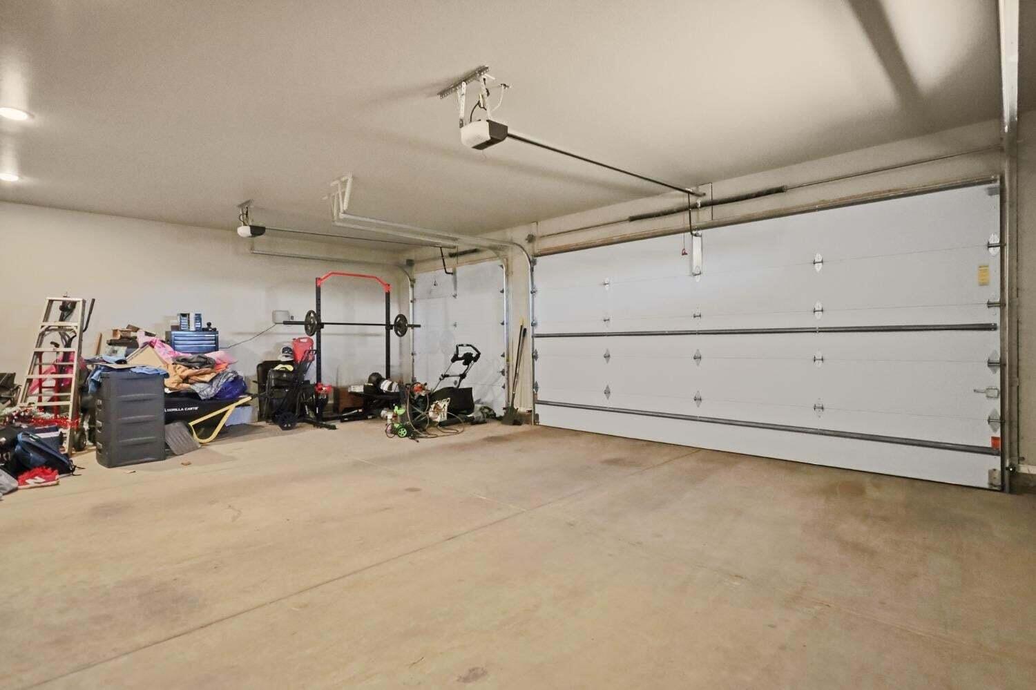 3416 141st Street Lubbock, TX 79423 - Photo 26 of 32 a view of a garage with the bike and car