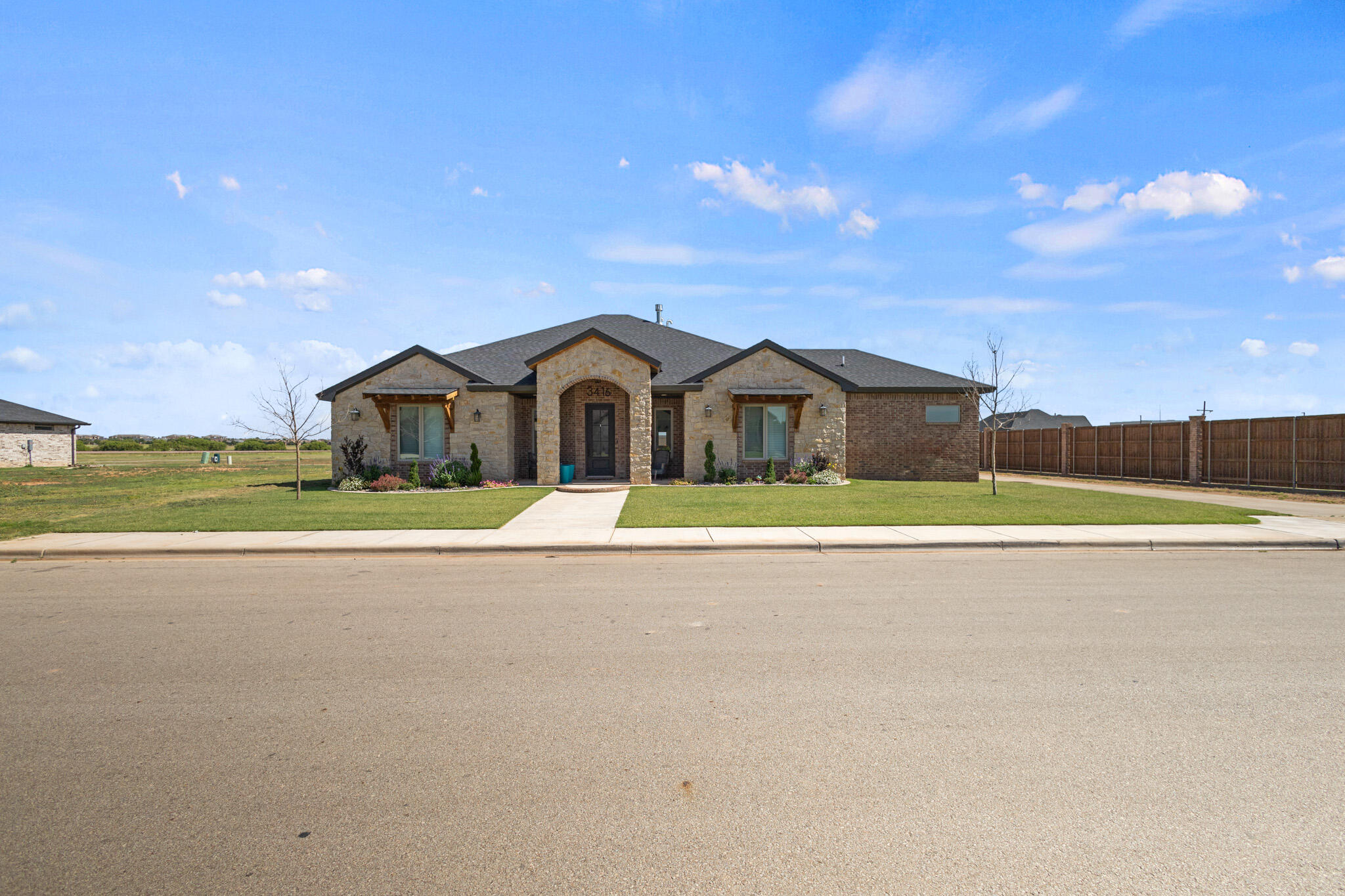 3416 141st Street Lubbock, TX 79423 - Photo 30 of 32 a view of white house with a big yard and a large tree