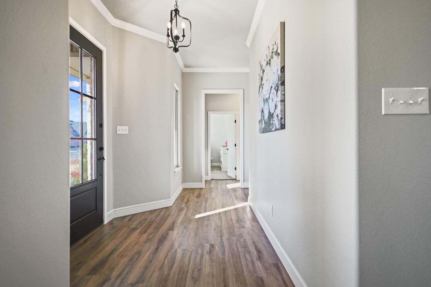 3416 141st Street Lubbock, TX 79423 - Photo 3 of 32 a view of a hallway view with wooden floor and staircase