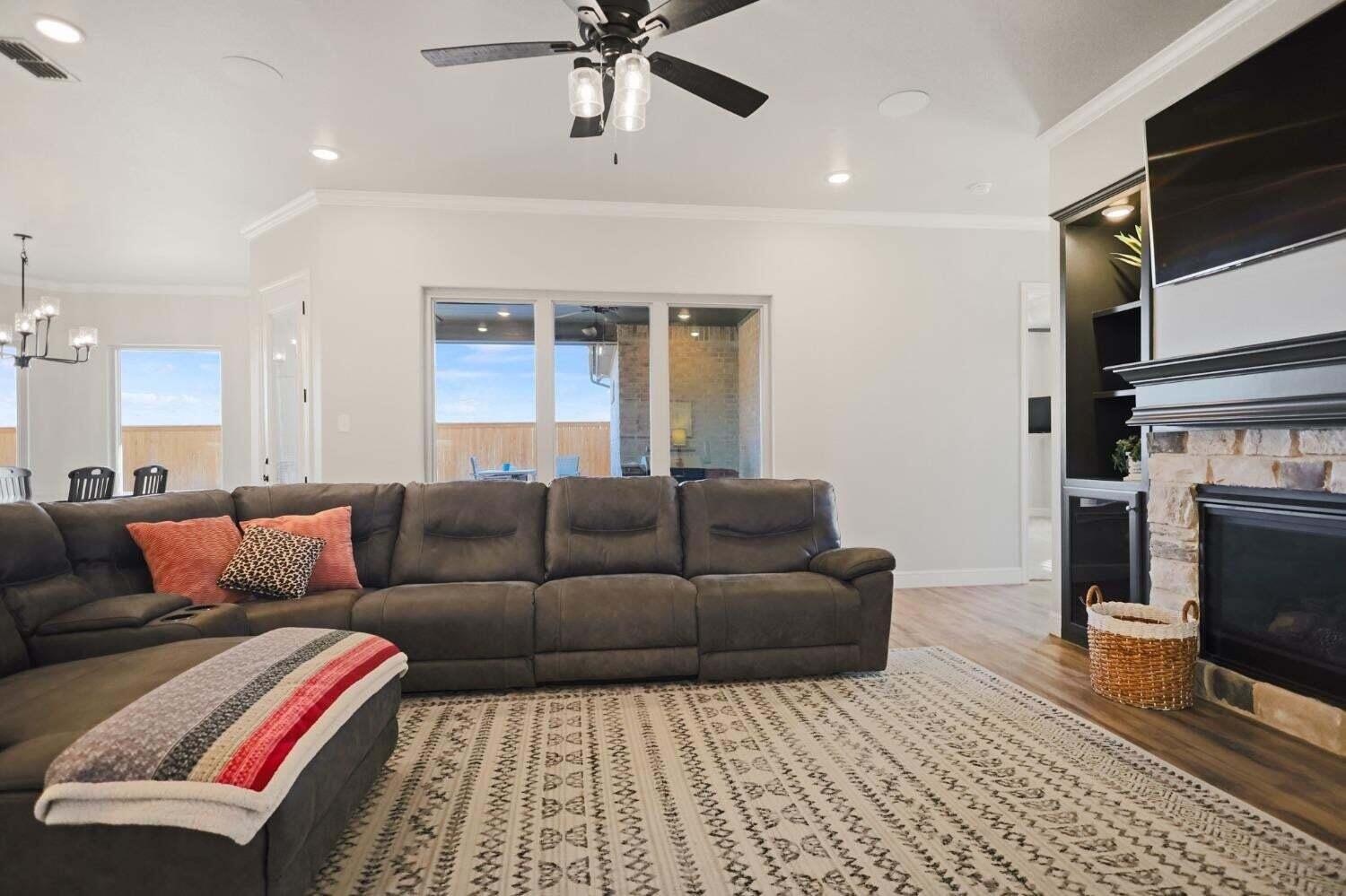 3416 141st Street Lubbock, TX 79423 - Photo 4 of 32 a living room with furniture and a fireplace